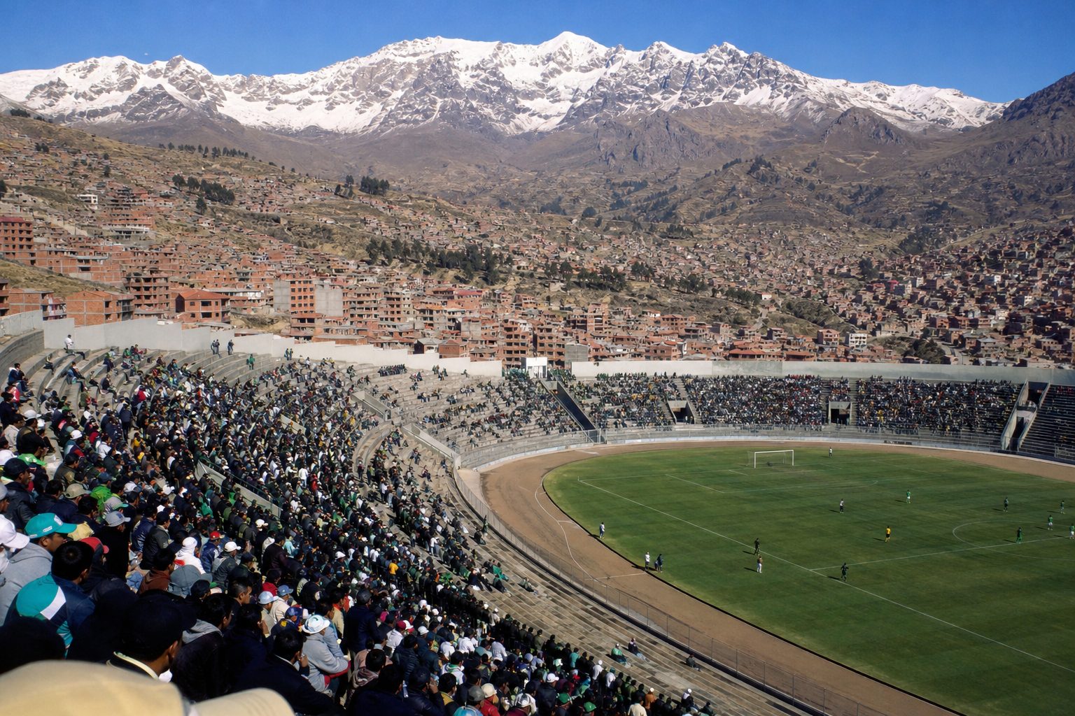 Concrete stadium stands beneath snow-capped Andean mountains on a clear afternoon (picture made with AI)