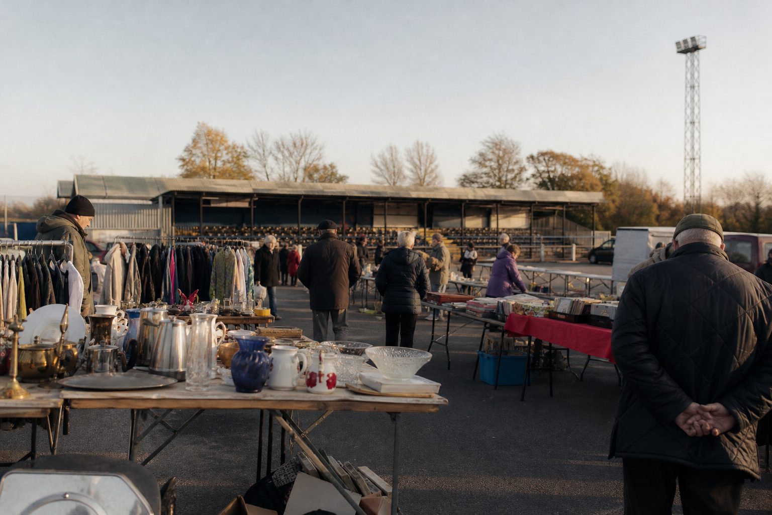 Car boot sale in a non-league club car park with pensioners browsing (picture made with AI)