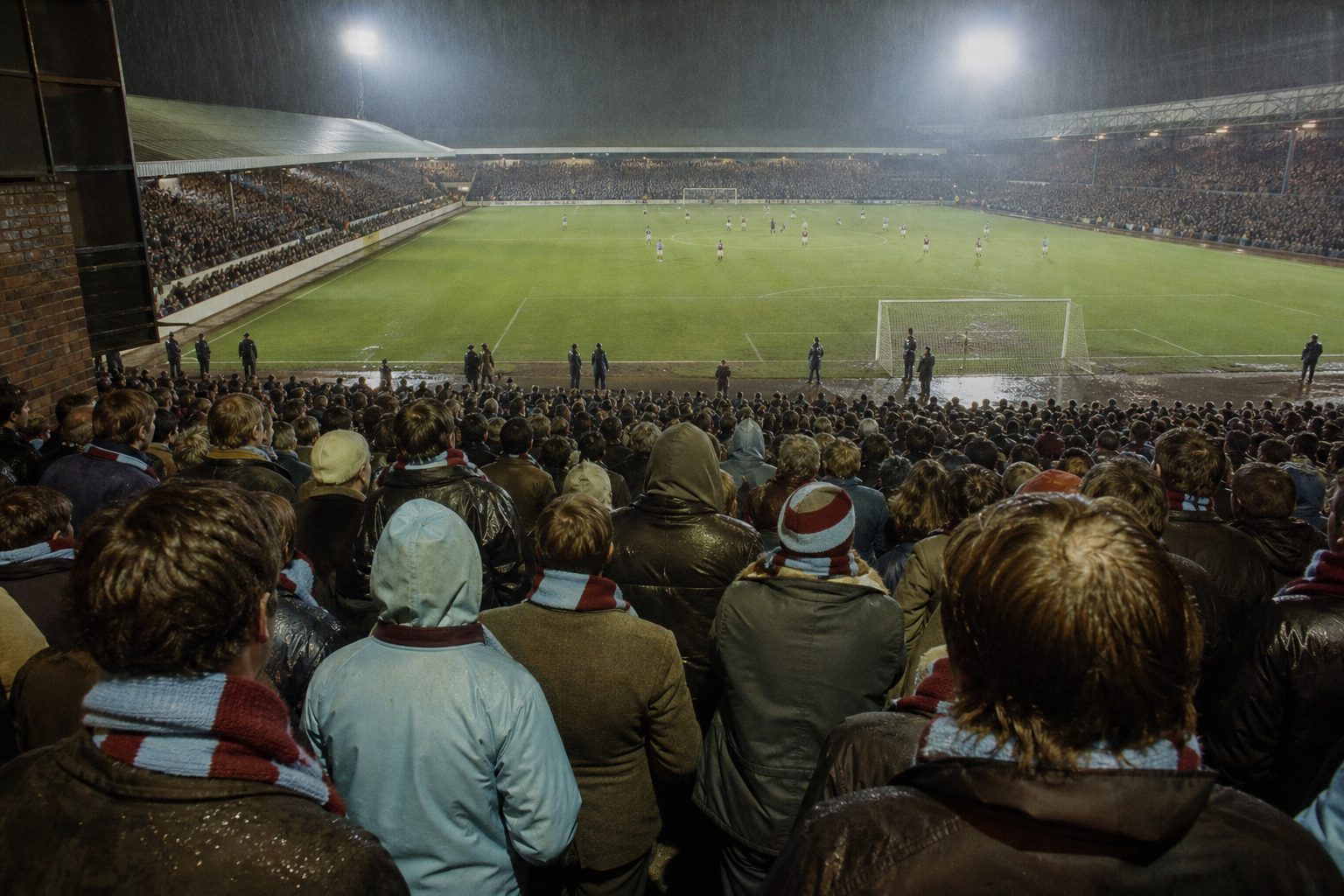 Supporters in claret and sky blue scarves on a rainy floodlit terrace at night (picture made with AI)