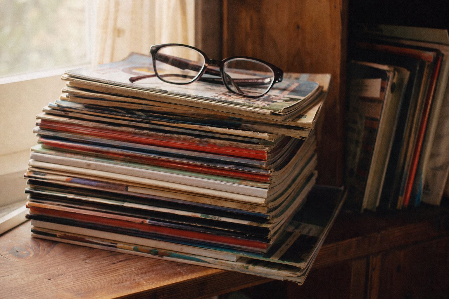 A stack of old football annuals and match programmes on a wooden shelf (picture made with AI)